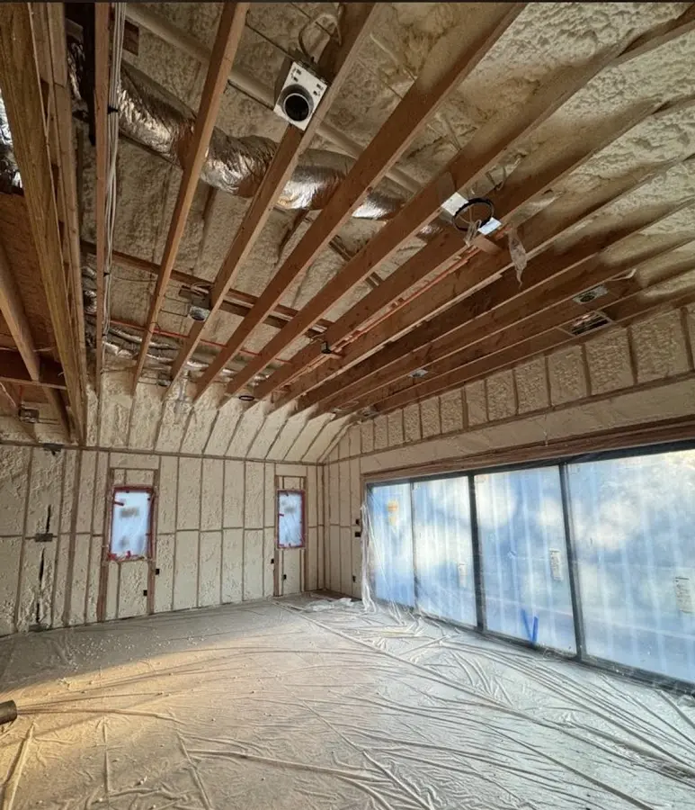 Interior walls and ceiling insulated with spray foam during new construction in Floral Park